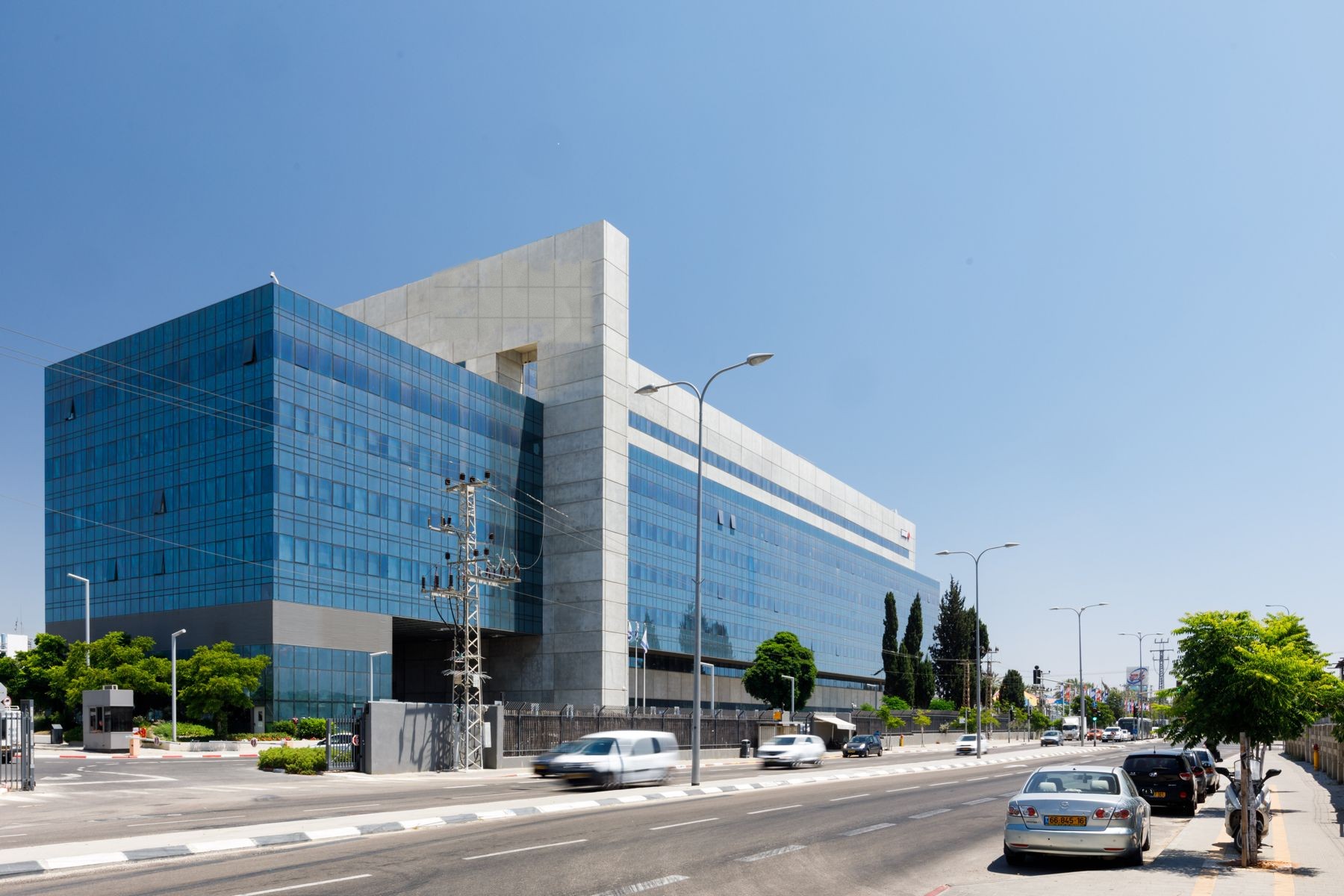 Office building with blue glass curtain wall and stone cladding